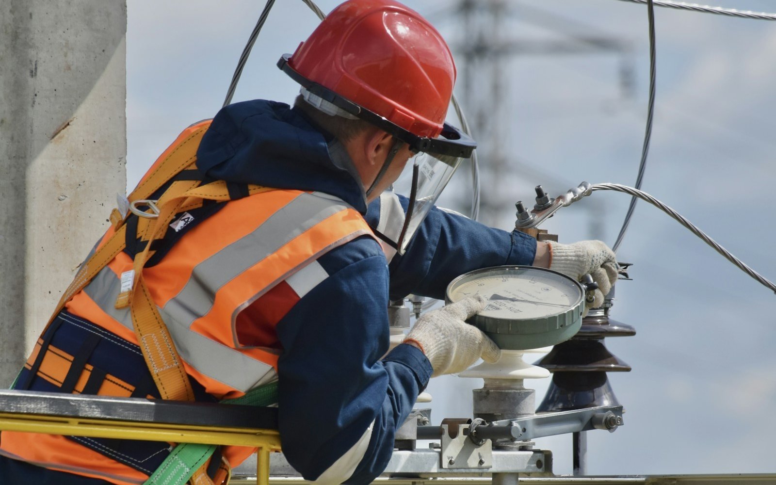 Technician wearing a safety helmet and high-visibility jacket