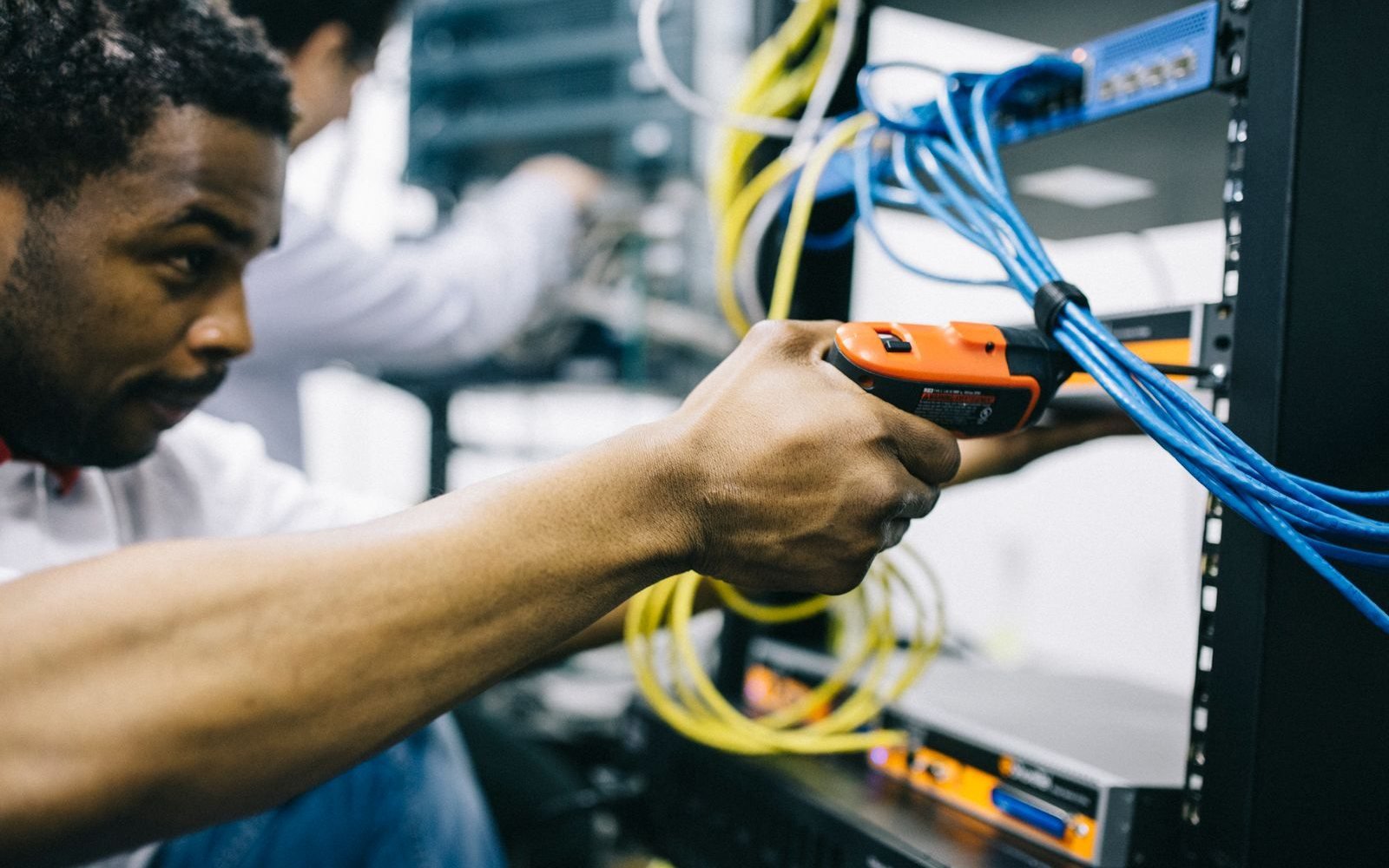 Technician installing equipment in a network rack