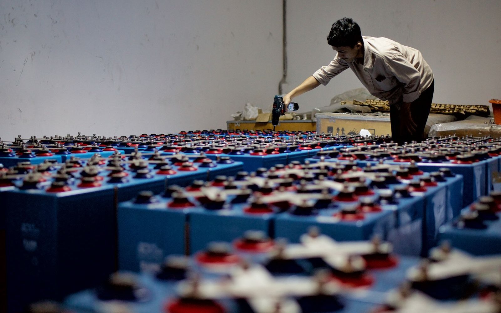 Technician inspecting a UPS battery bank